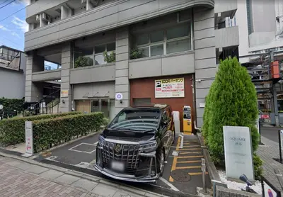 a car parked in a parking lot in front of a building at SQ) SHIBUYA HOUSE in Tokyo
