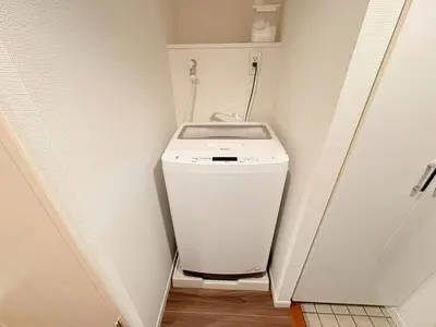 a small bathroom with a toilet in a hallway at SQ) SHIBUYA HOUSE in Tokyo