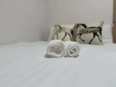 a couple of towels sitting on top of a bed at SQ) SHIBUYA HOUSE in Tokyo