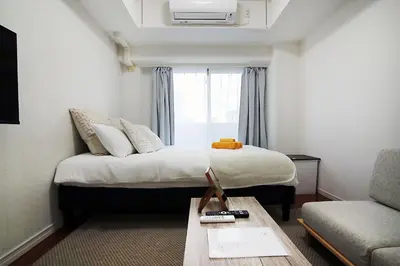 a hotel room with a bed and a window at SQ) SHIBUYA HOUSE in Tokyo