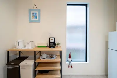 a small kitchen with a desk and a window at Maison Novel under Skytree in Tokyo