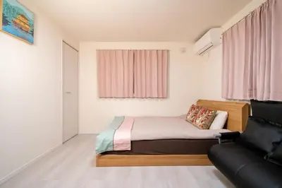 a small bedroom with a bed and a chair at Maison Novel under Skytree in Tokyo