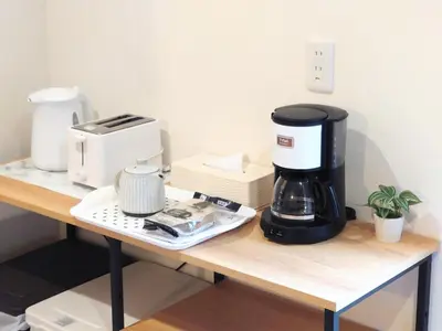 a coffee maker sitting on a table with a coffee pot at Maison Novel under Skytree in Tokyo