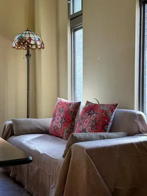 a living room with a couch and a lamp at PAThouse\u53f0\u4e1cAsakusa\u5e97 in Tokyo