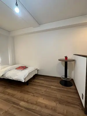 a bedroom with a bed and a table in it at PAThouse\u53f0\u4e1cAsakusa\u5e97 in Tokyo