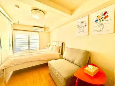 a bedroom with a bed and a couch and a table at Cube Stay \u5317\u6771\u4eac in Tokyo