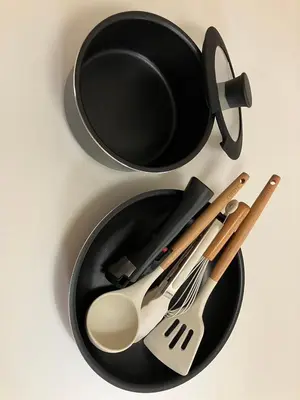 a black plate with utensils and a pan at Cube Stay \u5317\u6771\u4eac in Tokyo