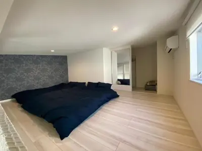 a bedroom with a large bed on a wooden floor at Building A - Vacation STAY 15789 in Tokyo
