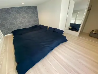 a blue comforter laying on the floor in a bedroom at Building A - Vacation STAY 15789 in Tokyo