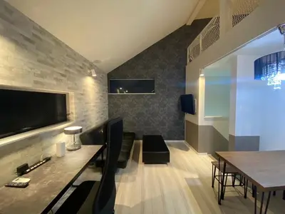 a living room with a table and a television at Building A - Vacation STAY 15789 in Tokyo
