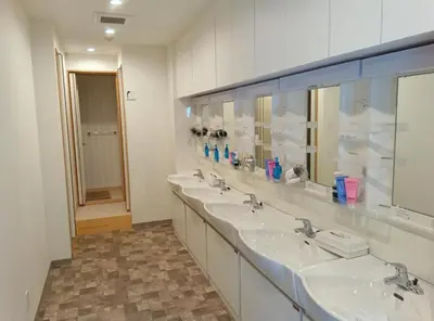 a bathroom with three sinks and a large mirror at Hostel Wasabi Asakusa in Tokyo