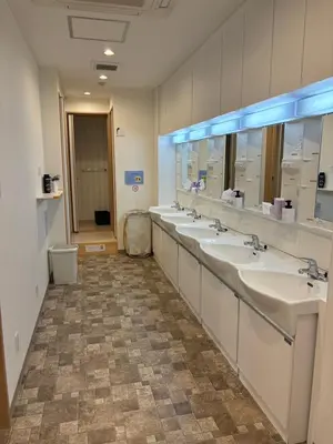 a bathroom with a row of sinks and mirrors at Hostel Wasabi Asakusa in Tokyo