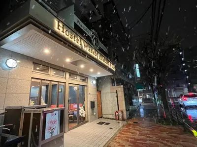 a building with a sign on the front of it at Hostel Wasabi Asakusa in Tokyo