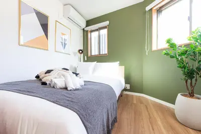 a bedroom with a bed with a stuffed animal on it at Pufuka Shin nakadori in Tokyo