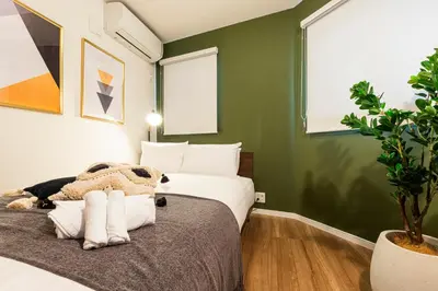 a bedroom with a bed and a potted plant at Pufuka Shin nakadori in Tokyo
