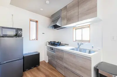 a kitchen with a sink and a refrigerator at Pufuka Shin nakadori in Tokyo