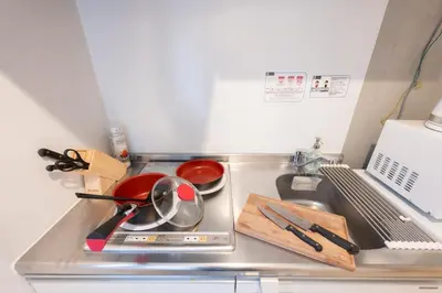 a kitchen counter with pots and pans on a stove at Rento Park Shiba 401 in Tokyo