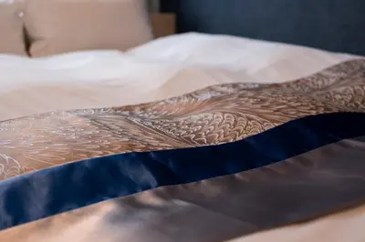 a blanket with a tattoo on a bed at Rento Park Shiba 401 in Tokyo