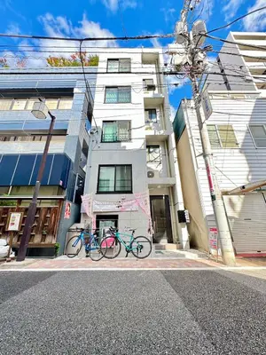 two bikes parked in front of a building at Rento Park Shiba 401 in Tokyo