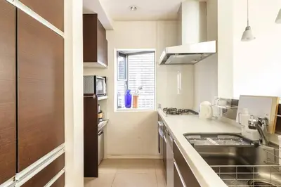 a kitchen with a sink and a counter top at Okusawa Private House in Tokyo
