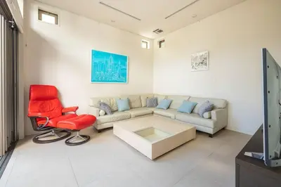 a living room with a couch and a red chair at Okusawa Private House in Tokyo