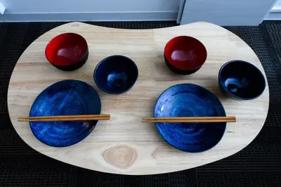 a group of bowls and chopsticks on a wooden plate at Rento Park Shiba 501 in Tokyo