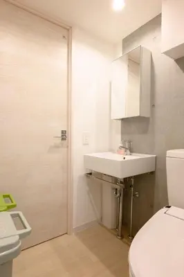 a bathroom with a sink and a toilet and a shower at Rento Park Shiba 501 in Tokyo