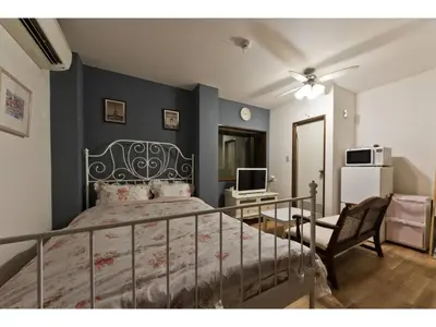 a bedroom with a bed and a desk and a television at Mini Hotel Shinjuku Front - Vacation STAY 89788v in Tokyo
