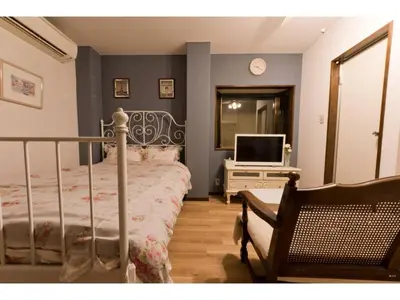 a bedroom with a bed and a television on a dresser at Mini Hotel Shinjuku Front - Vacation STAY 89788v in Tokyo