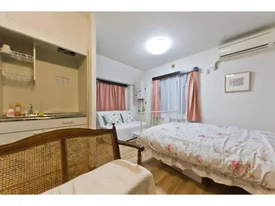 a bedroom with a bed and a chair in it at Mini Hotel Shinjuku Front - Vacation STAY 89788v in Tokyo