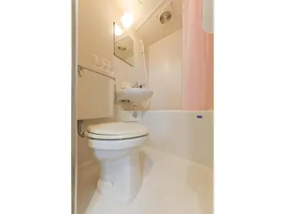 a white bathroom with a toilet and a sink at Mini Hotel Shinjuku Front - Vacation STAY 89788v in Tokyo