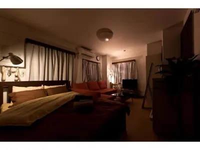 a bedroom with a bed and a couch in it at Mini Hotel Shinjuku Front - Vacation STAY 89774v in Tokyo