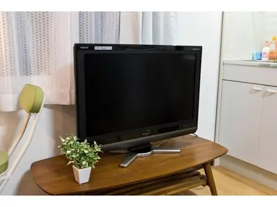 a flat screen tv sitting on top of a wooden table at Mini Hotel Shinjuku Front - Vacation STAY 89774v in Tokyo
