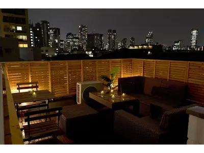 a balcony with a table and a view of a city at Mini Hotel Shinjuku Front - Vacation STAY 89794v in Tokyo