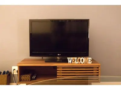a flat screen tv sitting on top of a wooden table at Mini Hotel Shinjuku Front - Vacation STAY 89794v in Tokyo