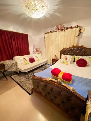 a bedroom with two beds and a chandelier at yiyi tokyo disney minpaku in Tokyo