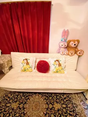 a white couch with stuffed animals on top of it at yiyi tokyo disney minpaku in Tokyo