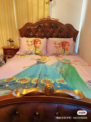 a bed with a painting of four dolls on it at yiyi tokyo disney minpaku in Tokyo