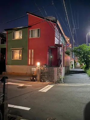 a red and green building on a street at night at yiyi tokyo disney minpaku in Tokyo