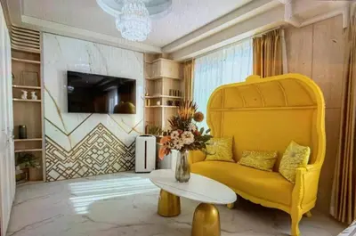 a living room with a yellow couch and a table at Reimi Mondo701 in Tokyo