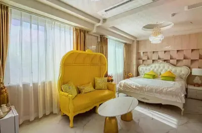 a bedroom with a yellow chair and a bed at Reimi Mondo701 in Tokyo