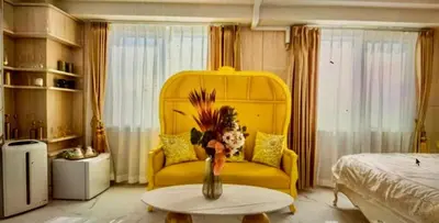 a living room with a yellow couch and a table at Reimi Mondo701 in Tokyo