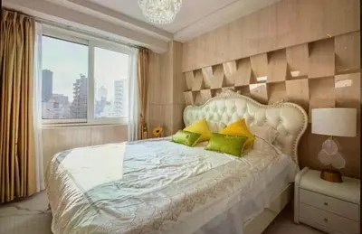a bedroom with a large white bed with green pillows at Reimi Mondo701 in Tokyo