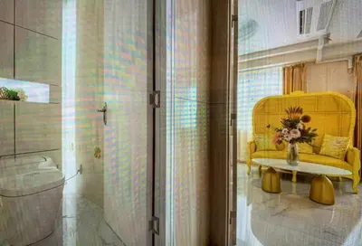 a room with a yellow chair and a table at Reimi Mondo701 in Tokyo