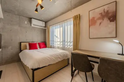a small bedroom with a bed and a desk at Ferio\u84b2\u7530 in Tokyo