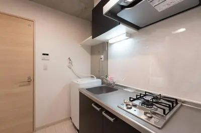 a small kitchen with a sink and a stove at Ferio\u84b2\u7530 in Tokyo