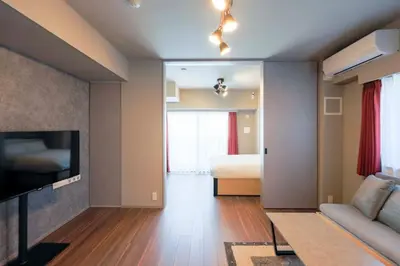 a living room with a television and a bed at Alterna\u8535\u524d in Tokyo