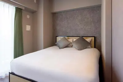 a bedroom with a large white bed and a window at Alterna\u8535\u524d in Tokyo