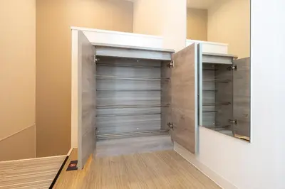 a walk in closet with wooden floors and gray doors at belle ville \u795e\u697d\u5742 in Tokyo