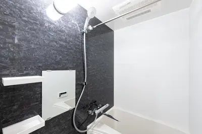 a bathroom with a shower with a light on the wall at belle ville \u795e\u697d\u5742 in Tokyo